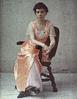 Woman in a chair with an orange silk dress