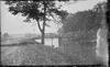 Bridge over river with log cabin
